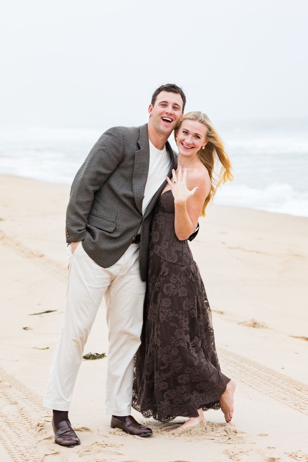 Lily showing her engagement ring beside a laughing Bryce